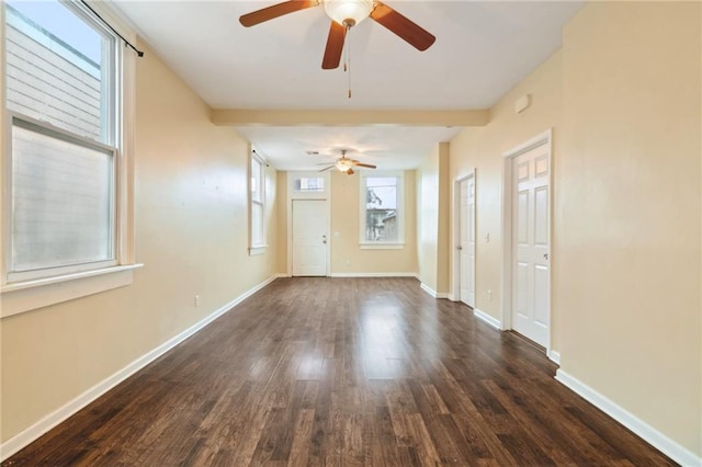 empty room featuring ceiling fan and dark wood-type flooring