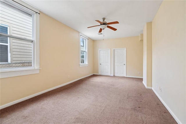 unfurnished room with ceiling fan and carpet flooring