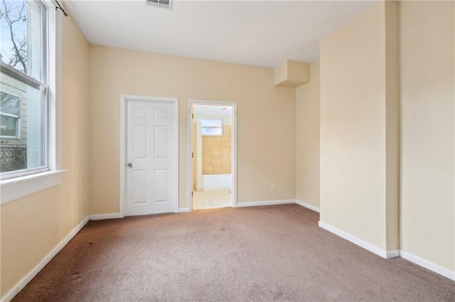 carpeted spare room with plenty of natural light