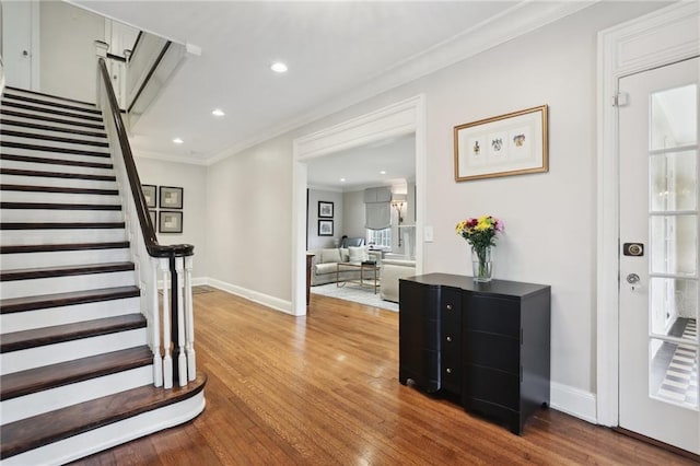 interior space with hardwood / wood-style flooring and ornamental molding