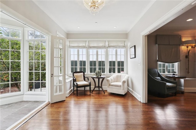 sunroom / solarium with a notable chandelier