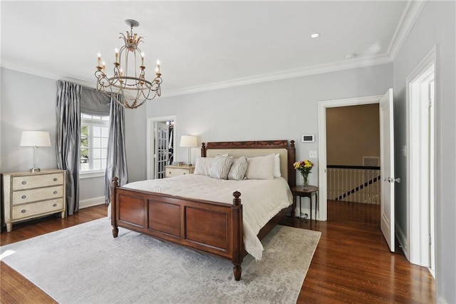 bedroom featuring dark hardwood / wood-style flooring, crown molding, and a chandelier