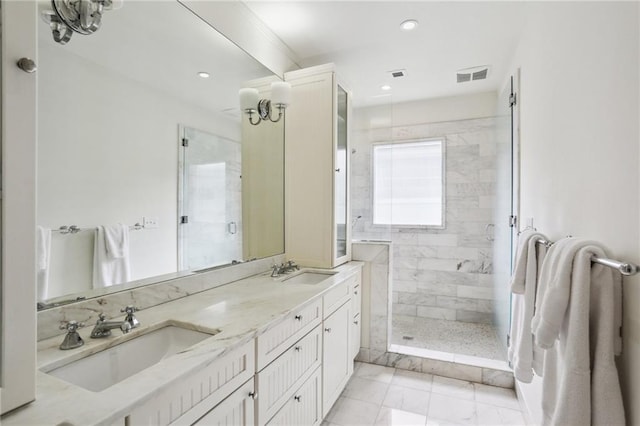 bathroom with vanity and tiled shower