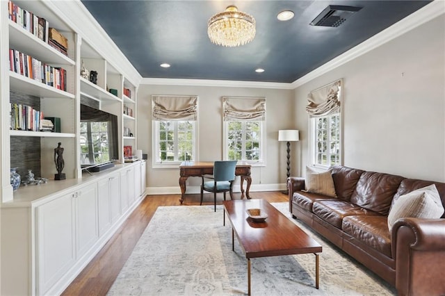 interior space featuring plenty of natural light, ornamental molding, and light hardwood / wood-style flooring