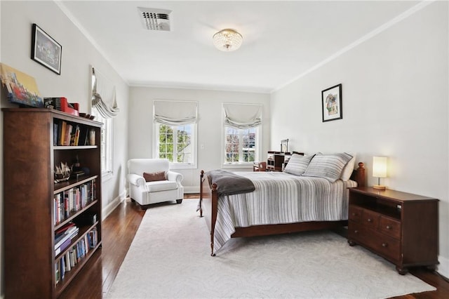 bedroom featuring wood-type flooring and ornamental molding