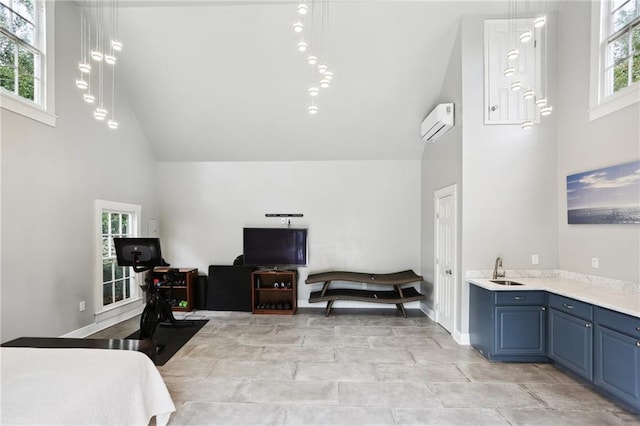 bedroom with high vaulted ceiling and an AC wall unit