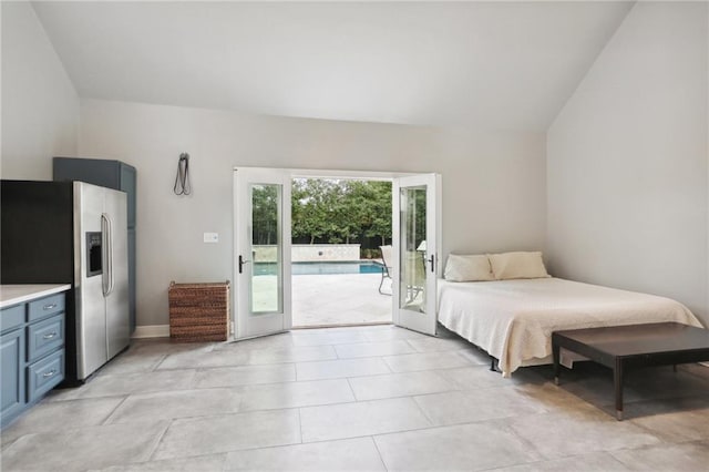 bedroom featuring stainless steel refrigerator with ice dispenser and access to exterior