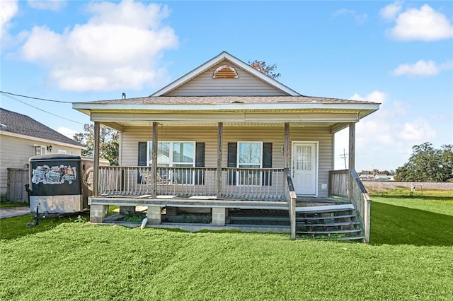 rear view of house with a lawn and a porch