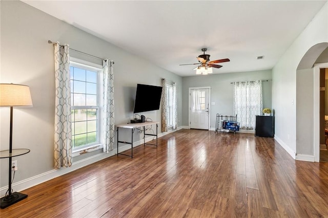 unfurnished living room featuring hardwood / wood-style floors, plenty of natural light, and ceiling fan