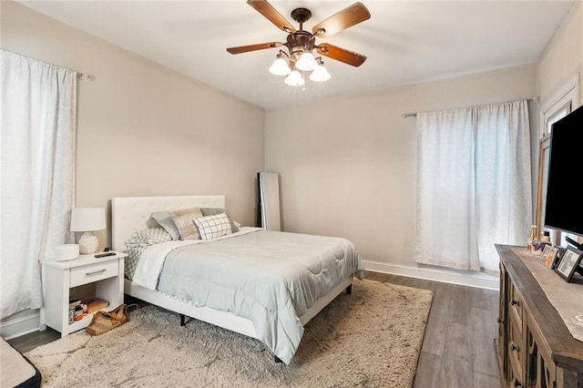 bedroom featuring ceiling fan and dark wood-type flooring