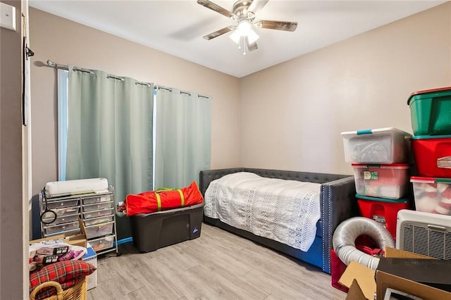 bedroom with hardwood / wood-style floors and ceiling fan