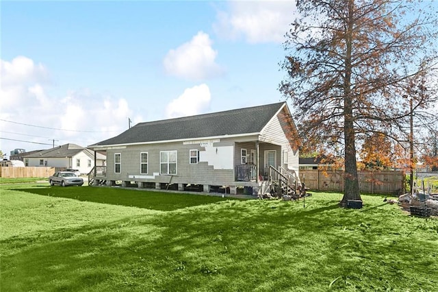 back of house featuring a lawn