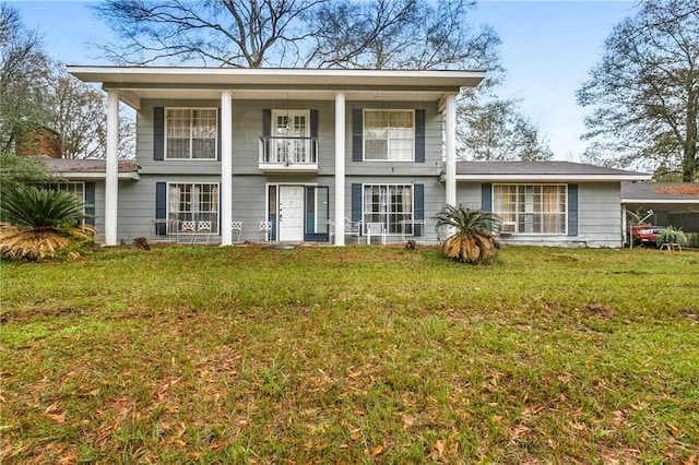 front facade with a balcony and a front lawn