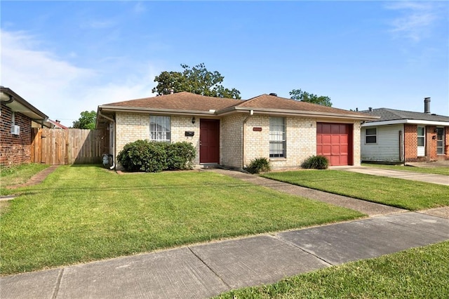 single story home featuring a garage and a front lawn