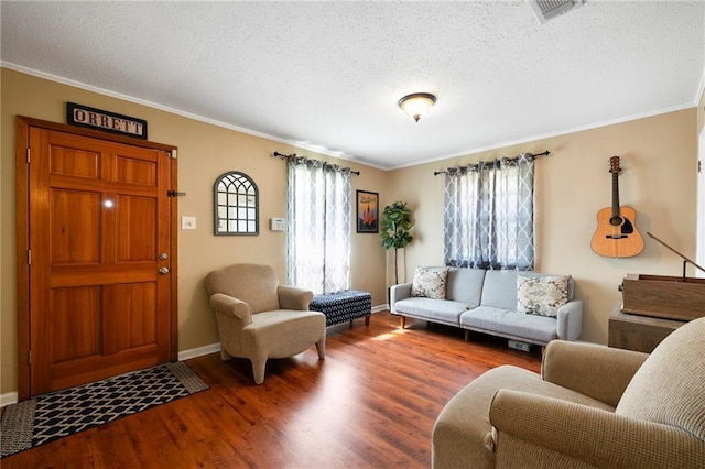 living room with a textured ceiling, hardwood / wood-style flooring, and crown molding