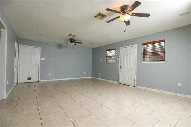 tiled empty room with ceiling fan