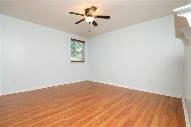 spare room featuring light wood-type flooring and ceiling fan