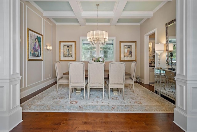 unfurnished dining area featuring coffered ceiling, ornamental molding, beam ceiling, dark hardwood / wood-style flooring, and a chandelier