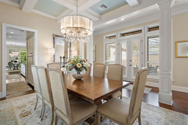 dining room with coffered ceiling, hardwood / wood-style flooring, ornate columns, beamed ceiling, and a healthy amount of sunlight