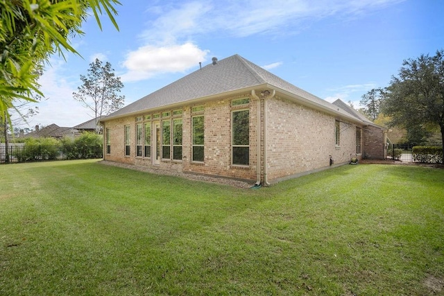 view of side of home with a lawn