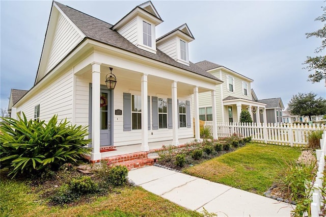 view of front facade featuring covered porch and a front yard