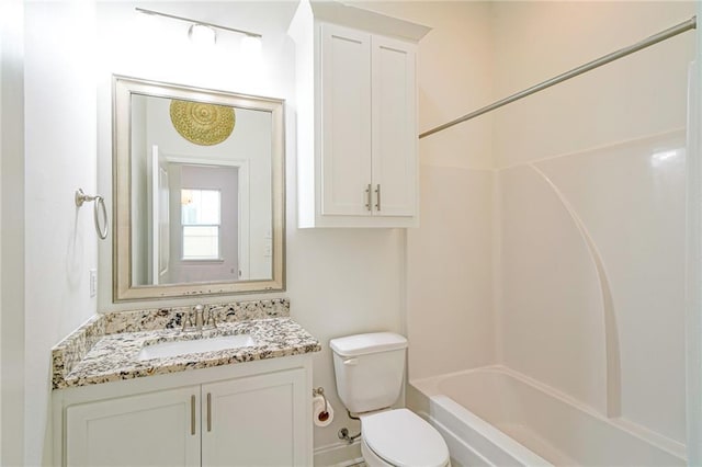 full bathroom featuring vanity, bathing tub / shower combination, and toilet