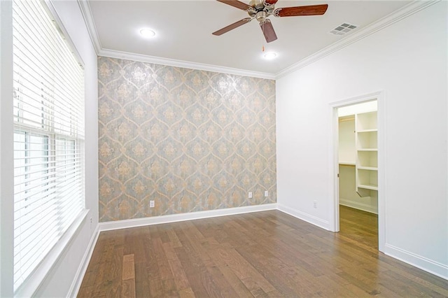 spare room featuring ceiling fan, ornamental molding, and dark hardwood / wood-style flooring