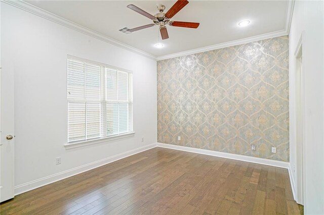 empty room with ceiling fan, ornamental molding, and hardwood / wood-style floors