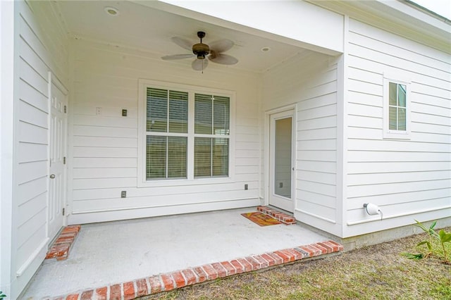 doorway to property featuring a patio and ceiling fan