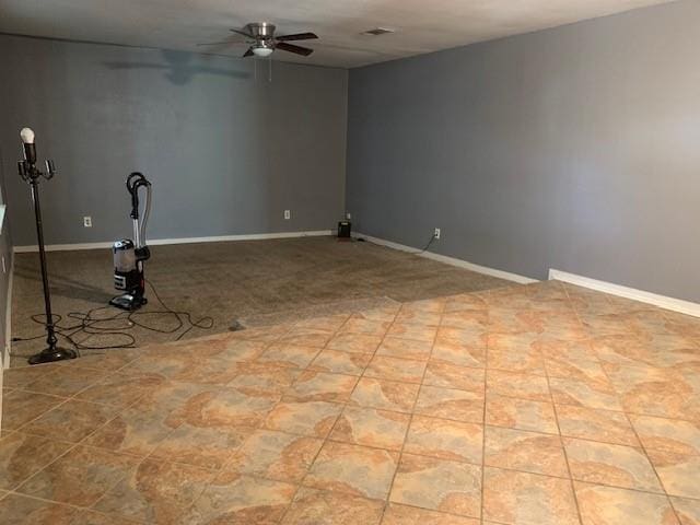 unfurnished room featuring ceiling fan and light tile patterned flooring