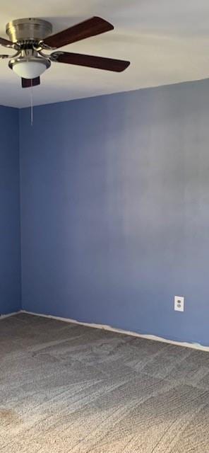 unfurnished room featuring ceiling fan and carpet floors