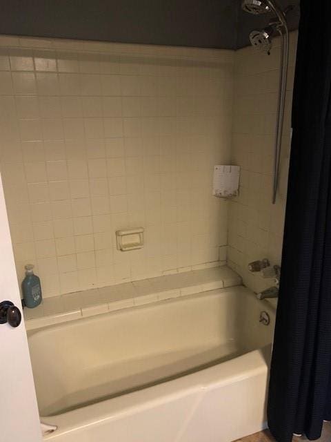 bathroom with shower / bathtub combination with curtain