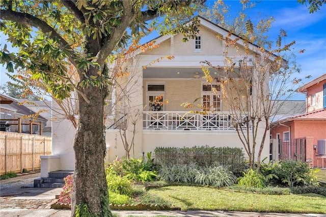 view of front of property with cooling unit, fence, and stucco siding