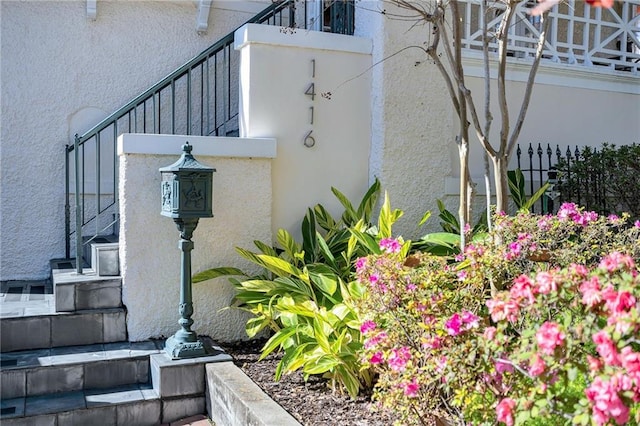 exterior space with stairs and stucco siding