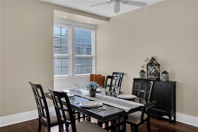 dining area featuring baseboards, dark wood finished floors, and a ceiling fan