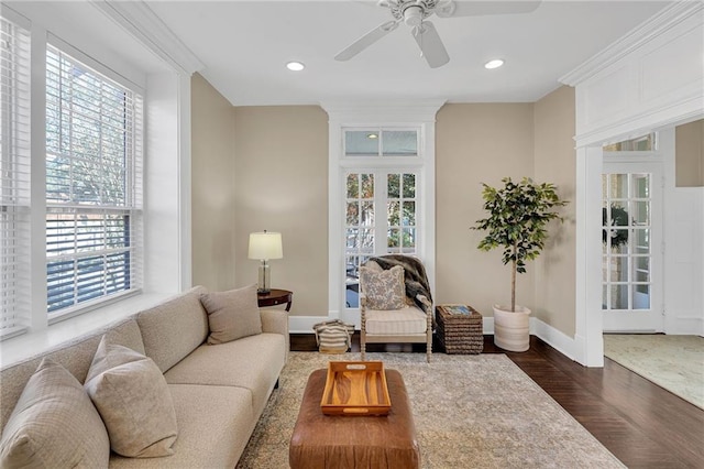 living room with baseboards, ceiling fan, ornamental molding, dark wood-style flooring, and recessed lighting