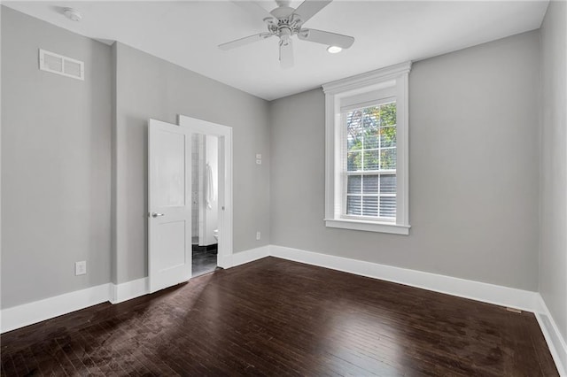 unfurnished bedroom featuring wood-type flooring, visible vents, and baseboards