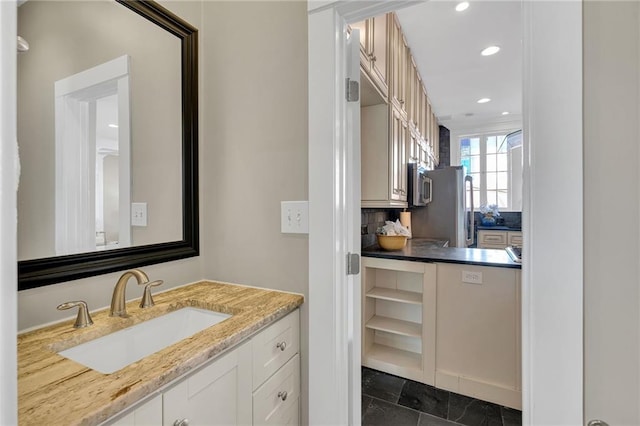 bathroom featuring tasteful backsplash, vanity, and recessed lighting