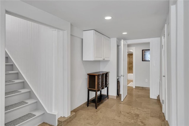 hall featuring stairway, recessed lighting, stone finish floor, and baseboards