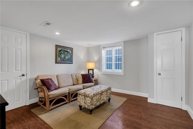 living area with recessed lighting, visible vents, baseboards, and wood finished floors