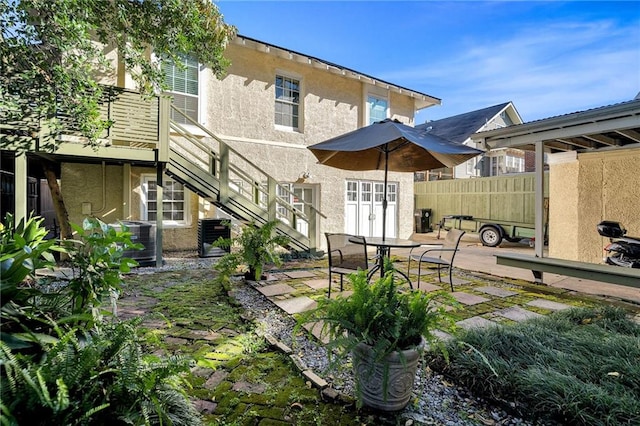 back of house with a patio, stairway, fence, cooling unit, and stucco siding