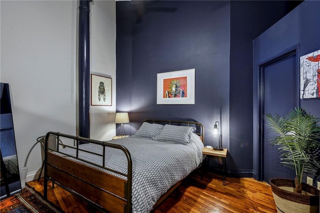 bedroom featuring wood finished floors and baseboards