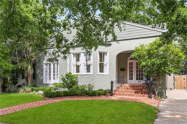 view of front facade with french doors and a front yard