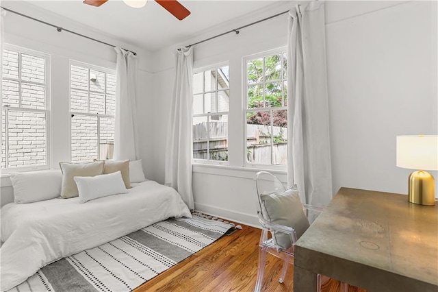 bedroom with ceiling fan and wood-type flooring