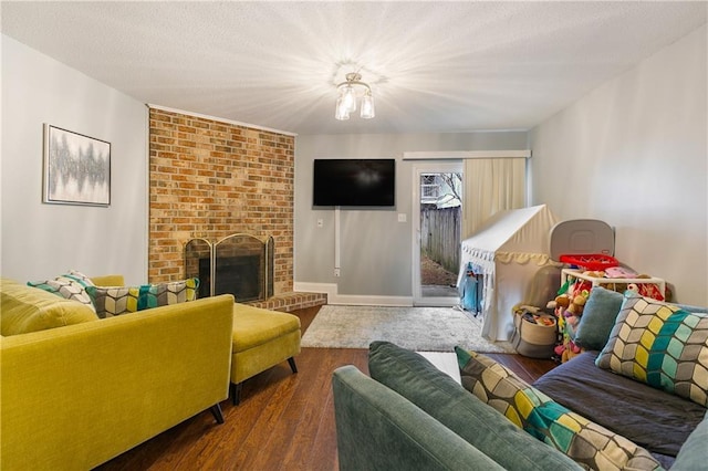 living room with a fireplace, a textured ceiling, and dark wood-type flooring