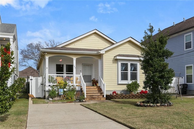 bungalow-style house with a porch and a front lawn