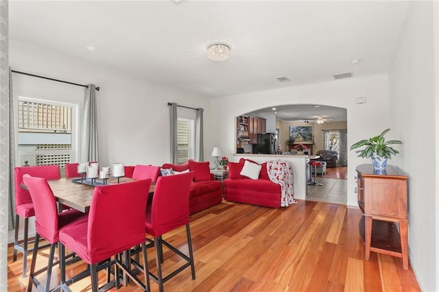 dining room with light hardwood / wood-style flooring and ceiling fan