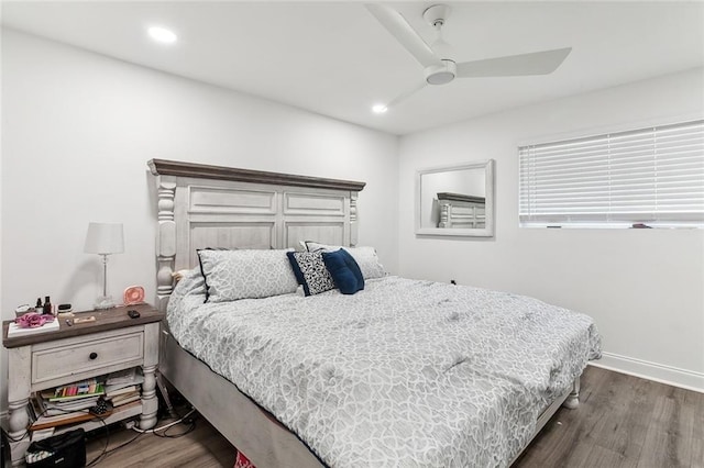 bedroom with ceiling fan and dark hardwood / wood-style floors