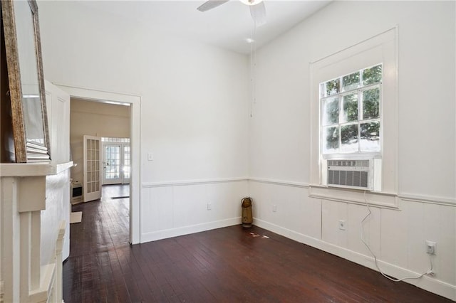 empty room featuring dark hardwood / wood-style floors, cooling unit, and ceiling fan