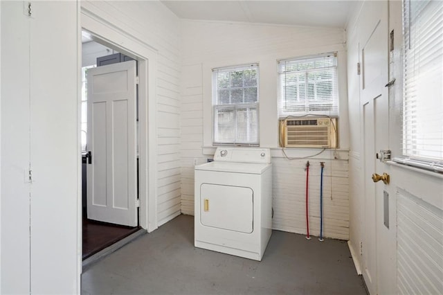 laundry area with washer / clothes dryer, wooden walls, and cooling unit